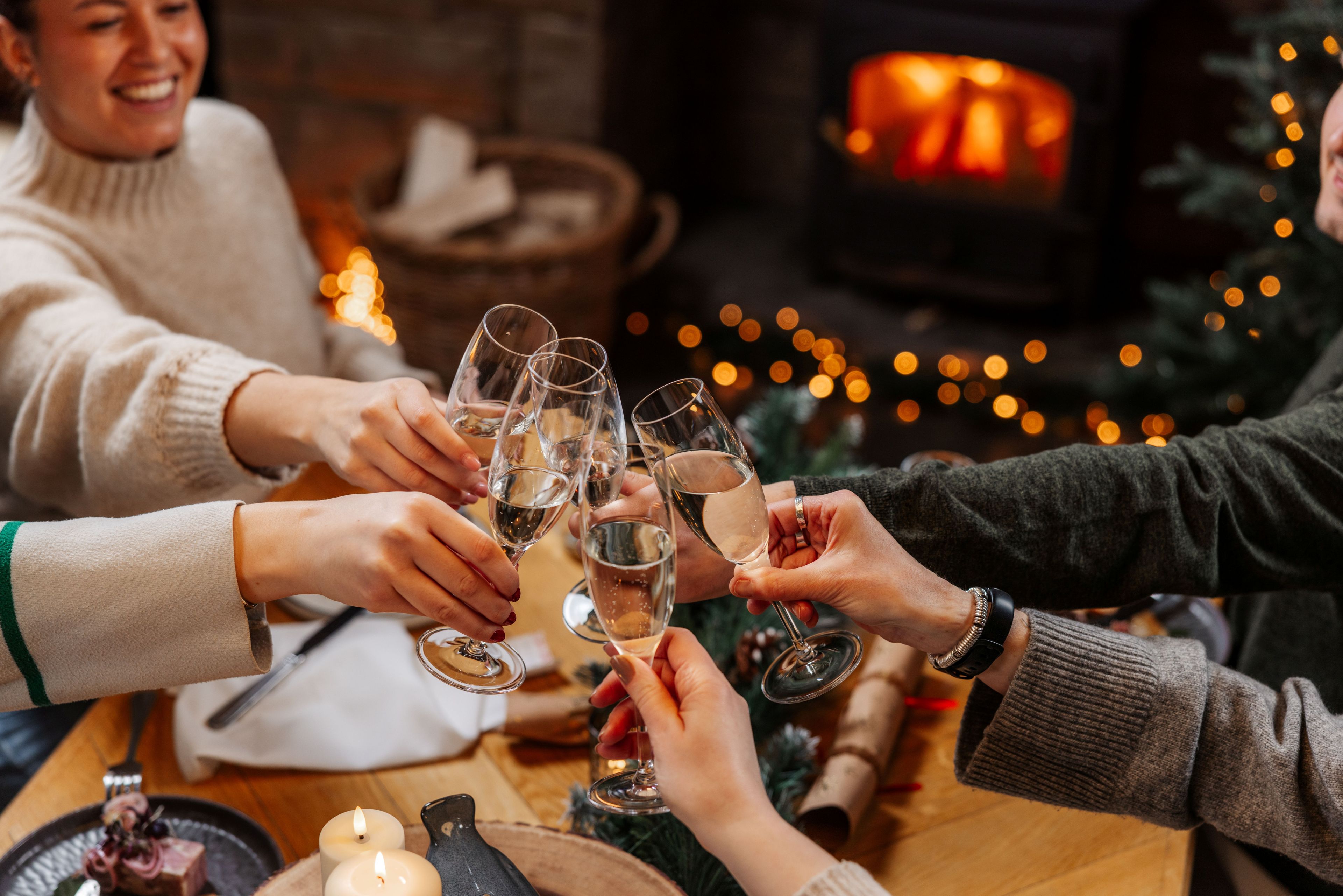 group of people clinking prosecco flutes in celebration